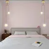 A bedroom scene with a bed, nightstand, and two pendant lights hanging above the bed. Produktbild-Vorschau