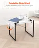 A sewing machine is placed on a white folding table with a blue fabric swatch. The table has a foldable side shelf that is extended. Produktbild-Vorschau