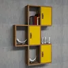 A modular wall shelf unit with yellow cabinet doors and wooden frames, mounted on a textured gray wall. Produktbild-Vorschau