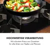A close-up of a gas stovetop with a wok full of vegetables being cooked. Produktbild-Vorschau
