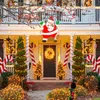 A house decorated for Christmas with lights, Santa Claus, and Christmas trees. Produktbild-Vorschau