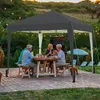 A family enjoys a meal under a dark gray canopy in a backyard setting. Produktbild-Vorschau