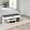 A shoe bench with storage is placed next to a bed in a bedroom. Produktbild-Vorschau