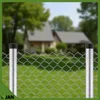 A chain-link fence with metal posts in front of a blurred house and lawn. Produktbild-Vorschau