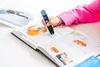 A person is using a scanning pen to read a book. Náhľad obrázku produktu