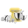 A yellow KitchenAid stand mixer with various attachments and bowls, displayed against a white background. Produktbild-Vorschau