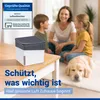 A family and their dog are relaxing in a living room, with a WENKO dehumidifier on a table. Produktbild-Vorschau