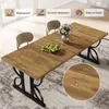 A dining table set up in a dining room with chairs and a vase of flowers. Produktbild-Vorschau