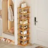 A corner shoe rack filled with shoes and a handbag, placed next to a door. Produktbild-Vorschau