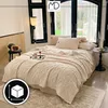 A bedroom scene with a bed covered in a thick, textured beige blanket. Anteprima dell’immagine prodotto