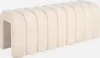 A beige upholstered bench with a curved, segmented design, shown against a white background. Produktbild-Vorschau
