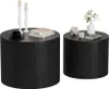 Two black cylindrical coffee tables with decorative items on top. Anteprima dell’immagine prodotto