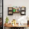 A wall-mounted wine rack with bottles and glasses, placed above a wooden table with decorative items. Podgląd zdjęcia produktu