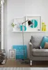 A living room scene with a sofa, floor lamp, and decorative items on a shelf. Náhľad obrázku produktu