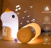 A unicorn-shaped night light and a cylindrical speaker are displayed on a textured surface, with musical notes floating around them. Produktbild-Vorschau