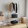 A clothing rack with clothes and bags in a room. Náhled obrázku produktu