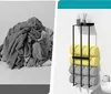 A split image showing a pile of gray towels on the left and a black towel rack with rolled towels on the right. Produktbild-Vorschau