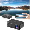 A mini projector is shown connected to a smartphone, with the projected image of a landscape displayed on a large screen in the background. Produktbild-Vorschau