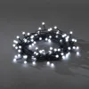 A string of white LED lights coiled on a gray surface. Produktbild-Vorschau