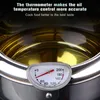A close-up of a deep fryer pot with oil and a thermometer. Podgląd zdjęcia produktu