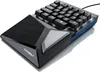 A close-up, angled studio shot of a black gaming keypad with blue accents on a white background. Voir les images du produit