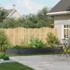 A backyard scene with a raised planter, fence, and patio furniture. Anteprima dell’immagine prodotto