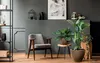A modern living room with a gray wall, wooden floor, and a chair with plants. Anteprima dell’immagine prodotto