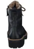 A black leather boot with fur lining and a thick sole, shown from the back. Produktbild-Vorschau