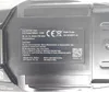 A close-up view of a black battery pack with a label containing product information and warnings. Voir les images du produit
