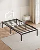 A black metal bed frame is displayed on a rug in a room. Produktbild-Vorschau
