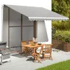 An outdoor patio scene with a table, chairs, and a grill under an awning. Produktbild-Vorschau