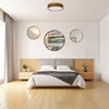 A bedroom scene with a bed, nightstands, and decorative mirrors on the wall. Anteprima dell’immagine prodotto
