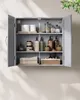 A gray medicine cabinet with various toiletries and towels displayed on its shelves. Náhled obrázku produktu
