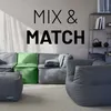 A modular seating arrangement with beanbag chairs and sofas in gray and green, set against a light gray wall with shadows. Náhled obrázku produktu