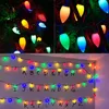A collage of Christmas lights on a tree and a wall with letters. Produktbild-Vorschau