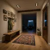 A hallway with a wooden bench, a rug, and a door. Anteprima dell’immagine prodotto