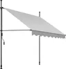 A light gray awning is extended from a black metal frame, supported by two vertical poles. The awning has a scalloped edge at the bottom. A crank handle is visible on the left pole. Náhled obrázku produktu