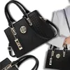 Multiple views of a black handbag, with one view showing a person holding it. Produktbild-Vorschau