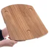 Hands holding a wooden board with circular indentations. Produktbild-Vorschau