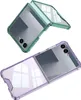 Two flip phone cases, one green and one purple, are shown against a white background. Produktbild-Vorschau