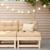 An outdoor seating area with a wooden sofa and string lights. Podgląd zdjęcia produktu