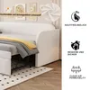 A daybed sofa is shown in a room setting with decorative artwork on the wall. The sofa is partially made up as a bed with bedding. Podgląd zdjęcia produktu