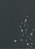 A close-up view of a dark gray textured fabric with water droplets on it. Voir les images du produit