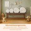 A collection of rolled-up baby blankets displayed on a bench in a nursery setting, with decorative elements like a teddy bear and a giraffe. Voir les images du produit