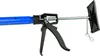A close-up view of a telescopic support pole with a black trigger mechanism and a black triangular end piece. Náhľad obrázku produktu