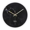 A round wall clock with a black marble design and gold hands. Anteprima dell’immagine prodotto