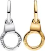 Two charms shaped like handcuffs, one silver and one gold, displayed side-by-side against a white background. Anteprima dell’immagine prodotto