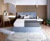 A bedroom scene featuring a bed with a mattress, a dressing table, and decor. Produktbild-Vorschau