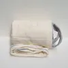 A rolled-up mattress protector with handles is placed on a white surface. Produktbild-Vorschau