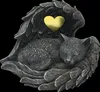 A statue of a sleeping cat curled up within angel wings, with a heart shape in the center. Anteprima dell’immagine prodotto